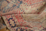Softened texture reveals madder red, navy, and beige hook and latch motifs.