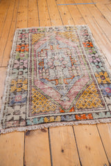 Vintage Oushak rug with oxidized silver ground, featuring distressed pale plum and saffron motifs.