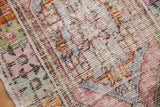 Distressed vintage Oushak rug pile with softened plum, saffron, slate, and oxidized silver tones.