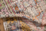 Distressed vintage Oushak rug texture with visible knot heads and muted plum, saffron, and tangerine tones.