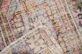 Vibrant, distressed pile and fringe on the folded corner of this vintage Oushak rug.