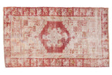 Distressed vintage Oushak runner, cherry red floral medallion, antique ivory, time-softened tones.
