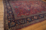 Cochineal red field with sprawling tendrils and palmettes on a vintage Persian Meshed rug.