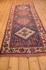 Antique Afshar runner end, featuring geometric border, indigo field, and people motifs.