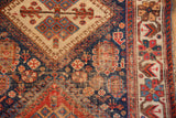 Antique Afshar runner detail, showcasing tribal geometric patterns, worn pile, and cream border with stylized motifs.