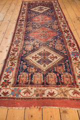 Antique Afshar runner end with madder root red fringe and geometric ivory border.
