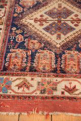 Afshar antique runner's indigo field with geometric people motifs and worn madder red edges.
