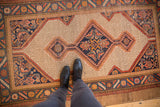 Vintage Serab rug's central diamond medallion, subtle geometric field, and intricate Herati spandrels.