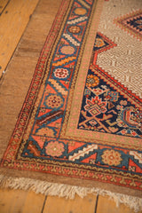 Vintage Serab rug corner detail, with navy Herati spandrel, camel field, and geometric borders.