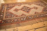 Vintage Camel Hair Serab rug's secured side edge with rich geometric border.
