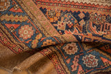 Folded detail of a Vintage Camel Hair Serab rug, showing worn pile, geometric lattice, and camel woven edge.