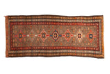 Vintage Serab runner with geometric medallions, red border, and floral motifs on a silver field.