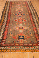 Vintage Serab rug detail: geometric medallion, floral motifs on silver field, red border.