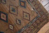 Antique Hamadan rug corner: aubergine patterned border, sky blue stripe, fringe, and wear.