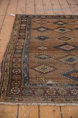 Antique Hamadan rug side with aubergine and blue geometric border, camel hair diamond field.