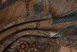 Antique Hamadan rug pile showing geometric diamond motifs in camel hair and aubergine.