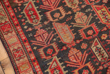 Vintage Caucasian rug detail, geometric animal motifs on abrash ground in indigo and madder red.