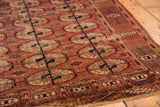 Turkmen Tekke rug detail: triple gul medallions, germinating plant border in chestnut, navy, ivory.