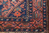 Vintage Malayer rug corner, raspberry Herati field and navy meandering vine border.