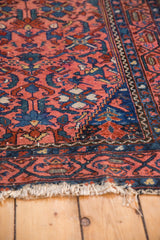 Tattered fringe and meandering vine boteh border on a vintage Malayer rug.