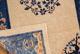 Ivory and cobalt blue antique Peking rug's hand-knotted reverse and aged, worn pile texture.
