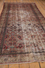 Antique Malayer rug end, showing foundation through worn Herati pattern and vine border.