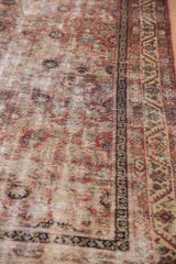 Antique Malayer runner's time-softened red and blue Herati motif with geometric border.