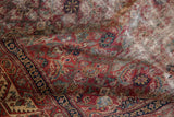 Antique Malayer rug detail showing madder red Herati motif, worn pile, and visible foundation.