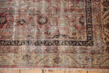 Worn field, exposed foundation, navy border, and natural fringe on an antique Malayer rug.