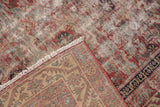 Hand-knotted foundation, fringed edge, and worn madder red, blue pile of antique Malayer rug.