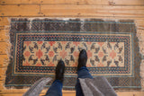 Tattered fringe and cobalt blue geometric borders on the rug's corner.