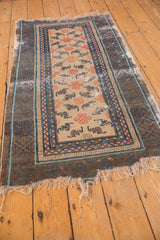 Ivory field of antique Ningxia runner with endless knot and scarce bat motifs, geometric borders.
