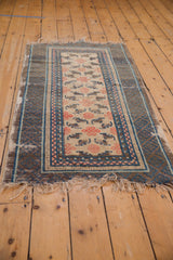 Frayed fringe and worn corner of antique Ningxia rug with endless knot and bat motifs.