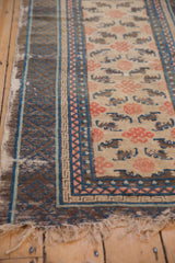 Tattered end fringe and key bat motifs on an antique Ningxia runner.