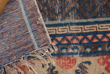 Antique Ningxia rug runner's foundation weave, tattered fringes, and worn pile.