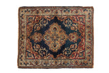 Antique hand-knotted Persian Kermanshah rug; navy field, wine red spandrels, gold medallion, floral vinery.
