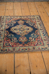 Patina on the traditional scrolling vinery and pawn border of this Kermanshah rug.