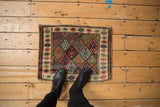 Antique Jaff Kurd bagface rug corner, repeating diamond field and finned floral border.