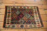Antique Jaff Kurd rug corner: geometric diamond field and ivory finned floral border.