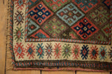 Ivory main border with finned floral design and fringed selvage on antique Jaff Kurd rug.