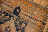 Worn geometric patterns, navy, terra cotta, and visible foundation on vintage Caucasian rug.