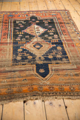 Worn, secured fringe and lower border with geometric rust, terra cotta, beige patterns.