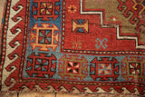 Vintage Caucasian rug corner: geometric guls, stepped contour in cherry red, navy blue, beige.