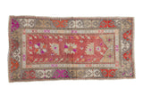 Distressed vintage Oushak rug with abrashed raspberry red field and serrated floral motifs, 2'5