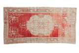 Distressed vintage Oushak rug runner: cherry red abrashed field, ivory roundel medallion, 3x5'10