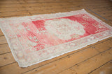 Distressed Oushak runner end: main border with weaver name, faded red and ivory pile.