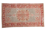 Distressed Oushak rug, blush and red floral medallion on an abrashed slate field.