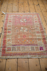 Vintage distressed Oushak rug corner, showing pink, bronze, mostly even wear to foundation.