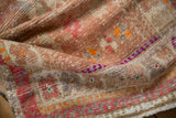 Distressed Oushak rug close-up, showing mostly even wear to knot heads, tangerine and purple tones.