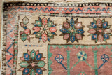 Distressed Oushak rug detail, dusty grape, mauve, emerald, sapphire blue floral motif, even wear.